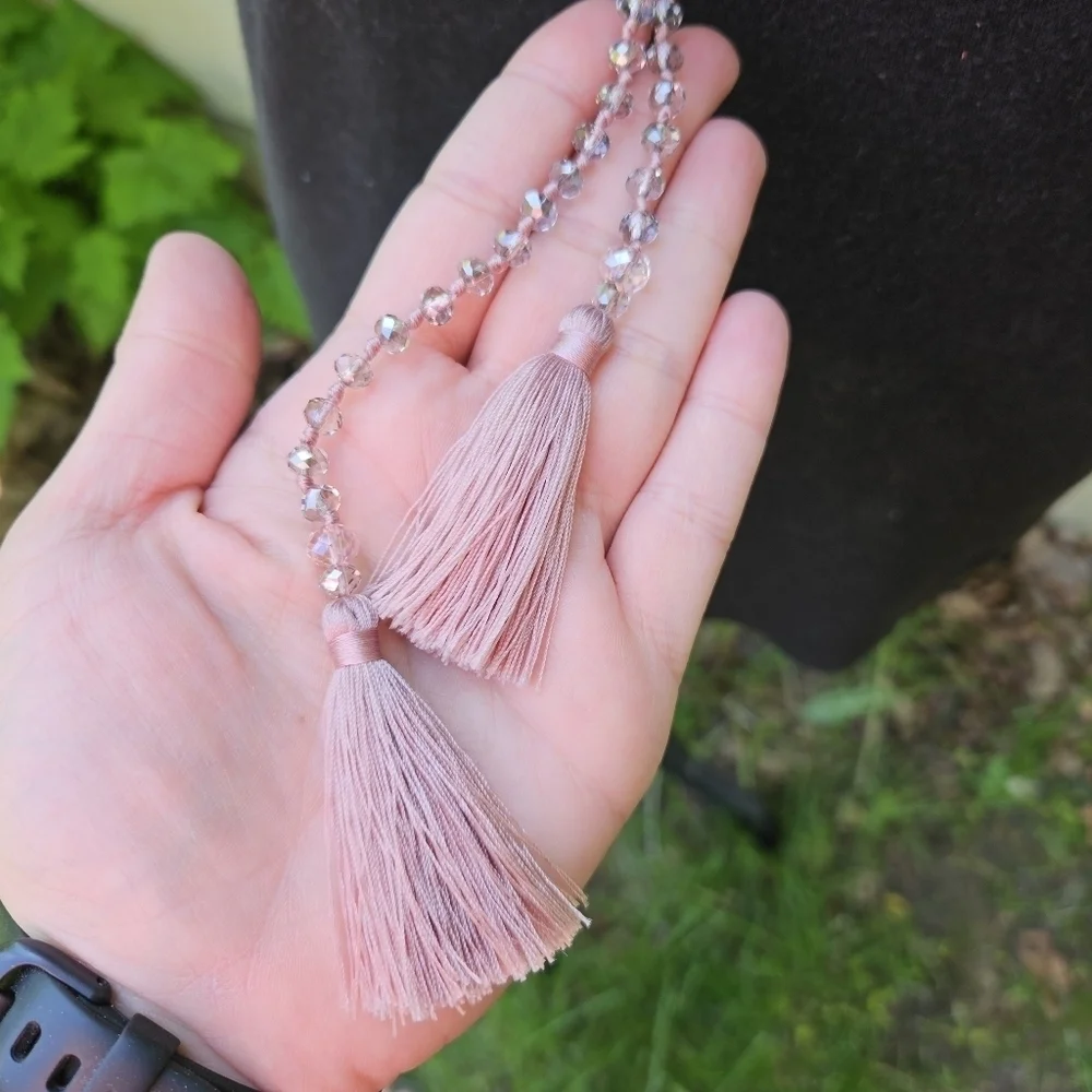 clear gray crystal beads on mauve cording with tassels
